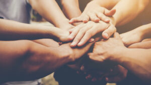 hands together in a circle representing support for frontline workers